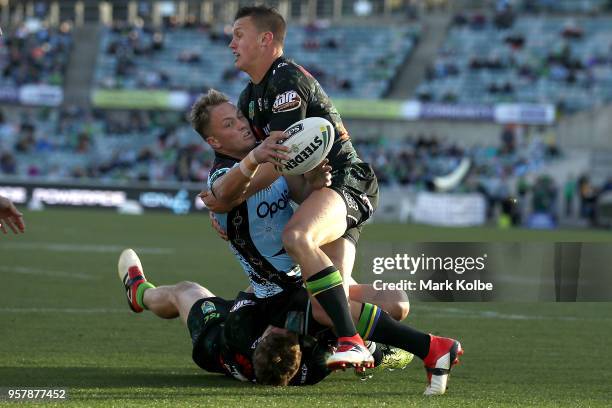 Matt Moylan of the Sharks is tackled by Jack Wighton of the Raiders during the round 10 NRL match between the Canberra Raiders and the Cronulla...