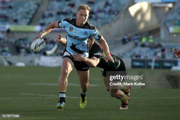 Matt Moylan of the Sharks is tackled during the round 10 NRL match between the Canberra Raiders and the Cronulla Sharks at GIO Stadium on May 13,...