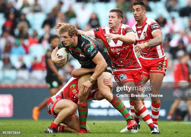 George Burgess of the Rabbitohs is tackled by the Dragons defence during the round 10 NRL match between the South Sydney Rabbitohs and the St George...