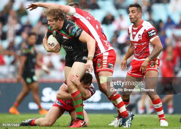 George Burgess of the Rabbitohs is tackled by the Dragons defence during the round 10 NRL match between the South Sydney Rabbitohs and the St George...