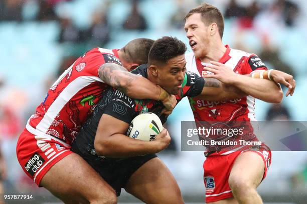 Tevita Tatola of the Rabbitohs is tackled by the Dragons defence during the round 10 NRL match between the South Sydney Rabbitohs and the St George...