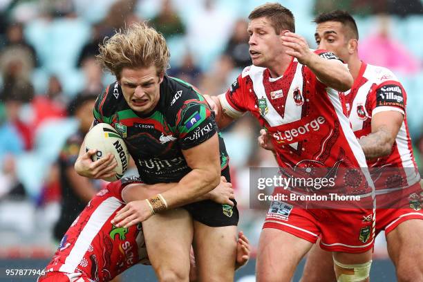 George Burgess of the Rabbitohs is tackled by the Dragons defence during the round 10 NRL match between the South Sydney Rabbitohs and the St George...