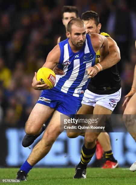 Ben Cunnington of the Kangaroos is tackled by Toby Nankervis of the Tigers during the round eight AFL match between the North Melbourne Kangaroos and...