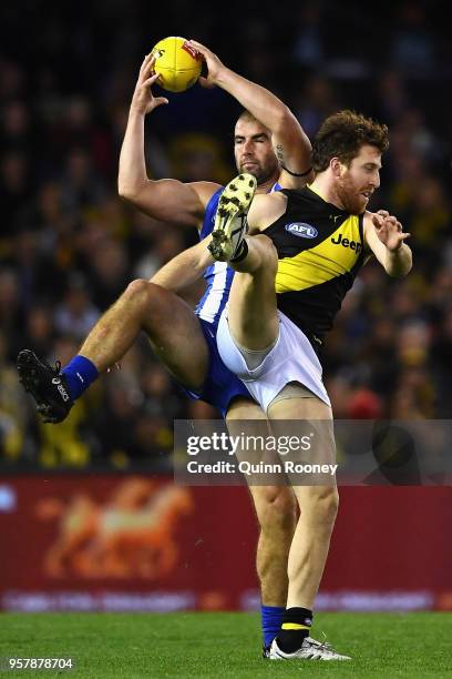 Ben Cunnington of the Kangaroos marks infront of Reece Conca of the Tigers during the round eight AFL match between the North Melbourne Kangaroos and...