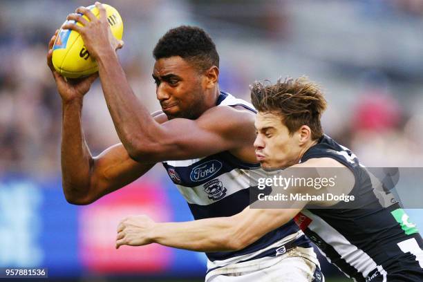 Josh Thomas of the Magpies tackles Esava Ratugolea of the Cats during the round eight AFL match between the Collingwood Magpies and the Geelong Cats...