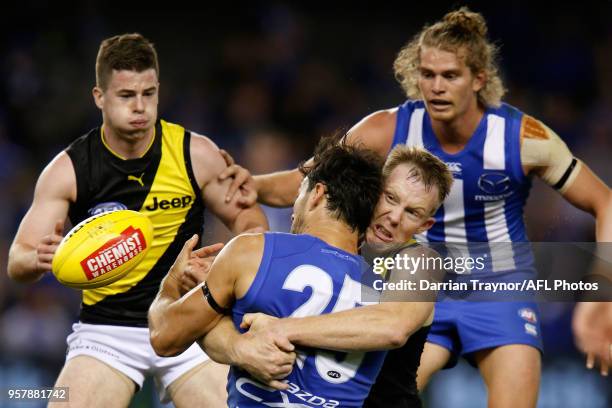 Jack Riewoldt of the Tigers tackles Robbie Tarrant of the Kangaroos during the round eight AFL match between the North Melbourne Kangaroos and the...