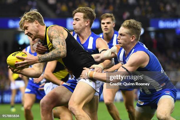 Nathan Broad of the Tigers is tackled by Jack Ziebell of the Kangaroos during the round eight AFL match between the North Melbourne Kangaroos and the...