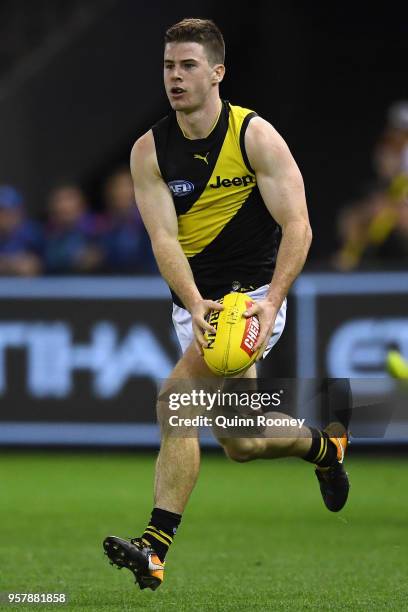 Jack Higgins of the Tigers kicks during the round eight AFL match between the North Melbourne Kangaroos and the Richmond Tigers at Etihad Stadium on...