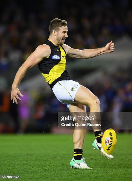 Kane Lambert of the Tigers kicks during the round eight AFL match between the North Melbourne Kangaroos and the Richmond Tigers at Etihad Stadium on...
