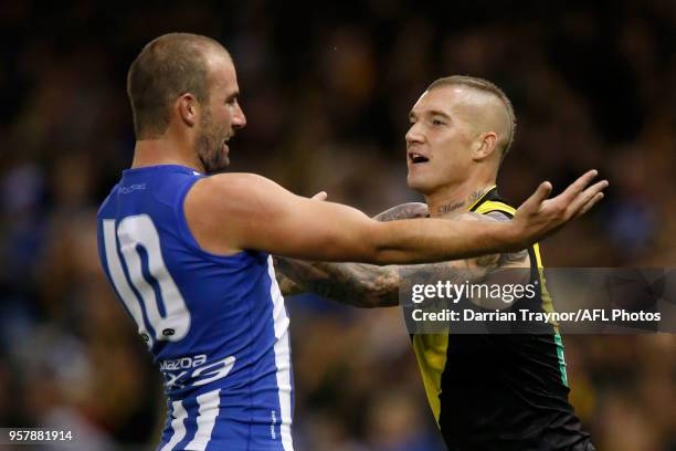 Ben Cunnington of the Kangaroos and Dustin Martin of the Tigers wrestle during the round eight AFL match between the North Melbourne Kangaroos and...