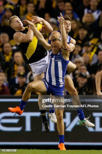 Josh Caddy of the Tigers marks the ball during the round eight AFL match between the North Melbourne Kangaroos and the Richmond Tigers at Etihad...