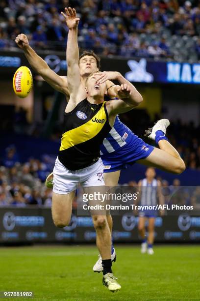 Jacob Townsend of the Tigers and Scott Thompson of the Kangaroos compete during the round eight AFL match between the North Melbourne Kangaroos and...