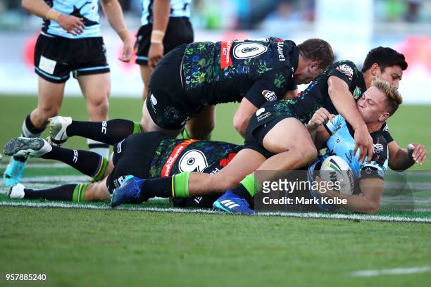 Matt Moylan of the Sharks is tackled during the round 10 NRL match between the Canberra Raiders and the Cronulla Sharks at GIO Stadium on May 13,...