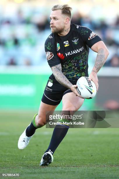 Blake Austin of the Raiders passes during the round 10 NRL match between the Canberra Raiders and the Cronulla Sharks at GIO Stadium on May 13, 2018...