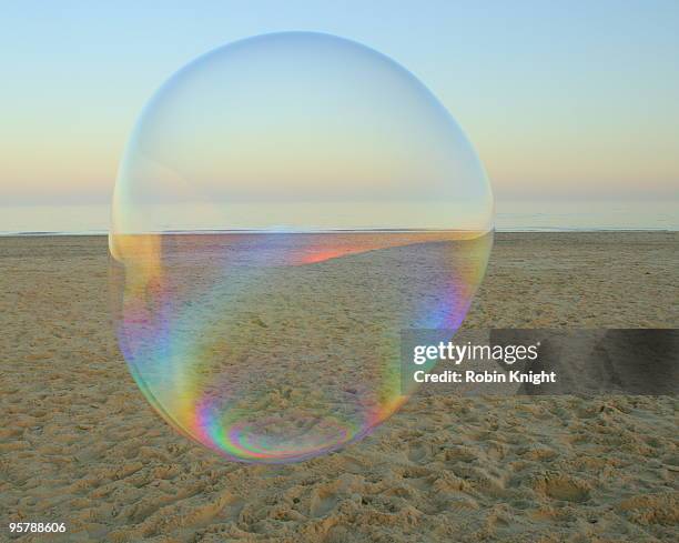 a large soap bubble floats on the beach - big bubble stock-fotos und bilder