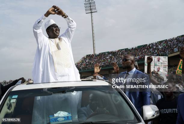 Union for the Republic and Democracy (Union pour la république et la démocratie, leader Soumaïla Cissé waves as he greets supporters at a rally...