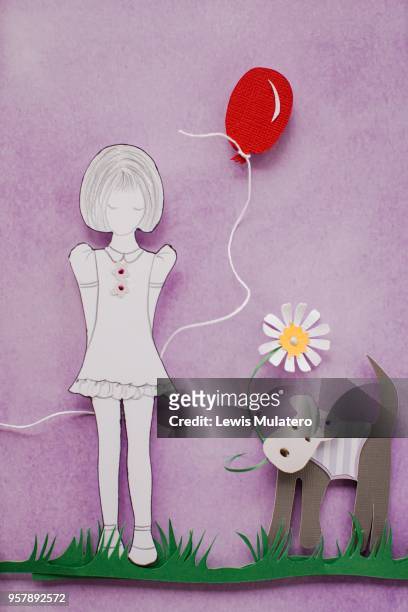 paper craft picture of a girl holding a red balloon with a little dog holding a daisy in its mouth - paper balloon photos et images de collection
