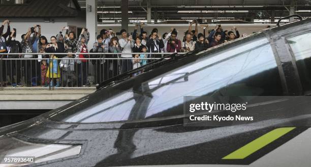 People crowd a platform at JR Shin-Osaka Station in western Japan on May 13 to see off the final run of West Japan Railway Co.'s special 500 Type Eva...