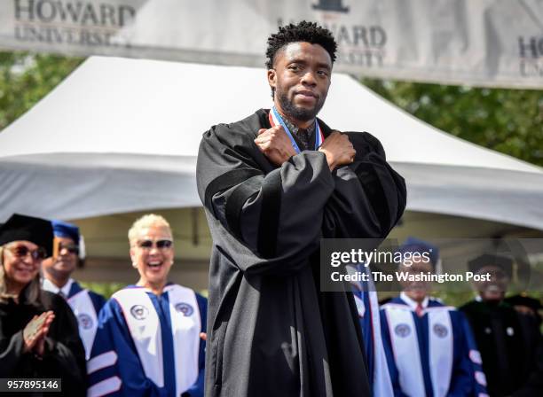 Actor Chadwick Boseman gives a Wakanda salute to the crowd as Howard University holds its' commencement ceremonies on May 2018 in Washington, DC.