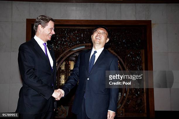 Chinese Foreign Minister Yang Jiechi shakes hand with Germany's Vice Chancellor and Foreign Minister Guido Westerwelle before a meeting at the...