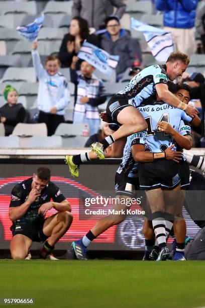 Sosaia Feki of the Sharks celebrates with his team mates after scoring a try during the round 10 NRL match between the Canberra Raiders and the...