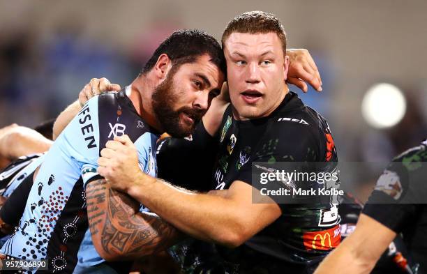 Andrew Fifita of the Sharks and Shannon Boyd of the Raiders look at the referee during a scrum in the round 10 NRL match between the Canberra Raiders...