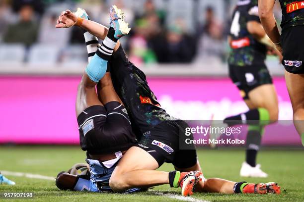 James Segeyaro of the Sharks is tackled Jack Wighton of the Raiders during the round 10 NRL match between the Canberra Raiders and the Cronulla...