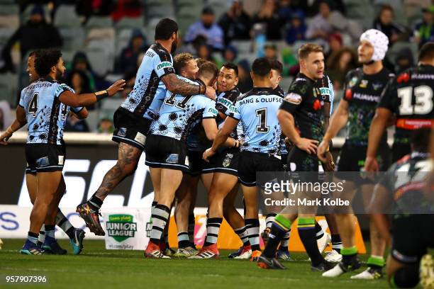 The Sharks celebrate with Jack Williams of the Sharks after he scored a try during the round 10 NRL match between the Canberra Raiders and the...