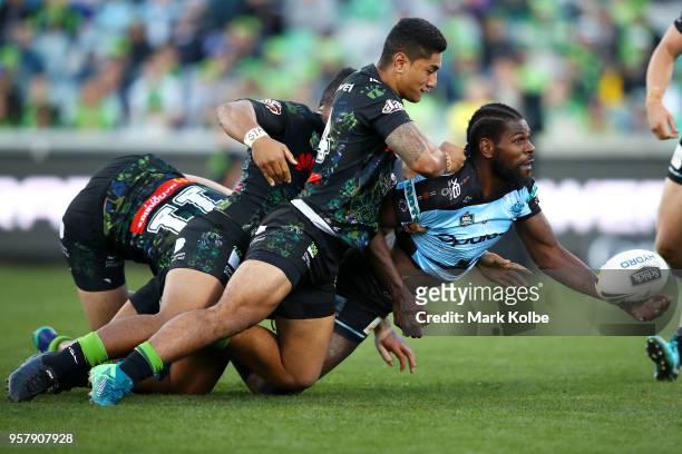 Edrick Lee of the Sharks passes as he is tackled during the round 10 NRL match between the Canberra Raiders and the Cronulla Sharks at GIO Stadium on...