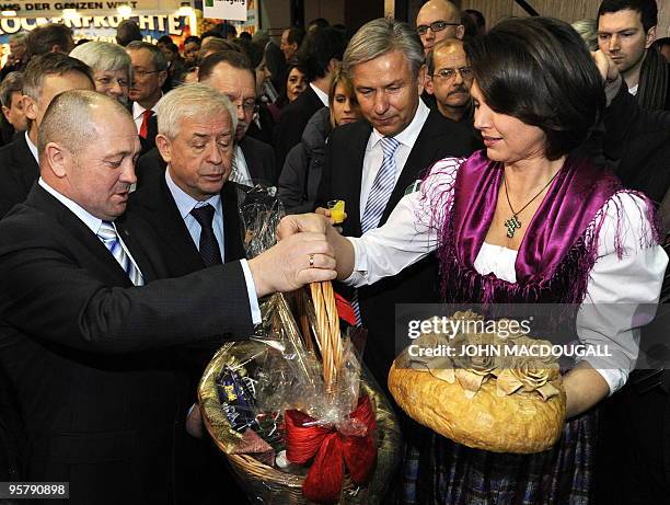 German Agriculture Minister Ilse Aigner receives gifts from Polish Agriculture Minister Marek Sawicki as she visits the Poland stand at the...