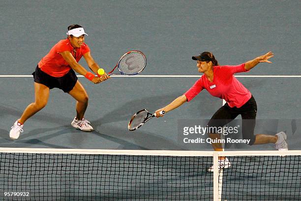 Yung-Jan Chan of China and Monica Niculescu of Romania volley in their semi final match against Su-Wei Hsieh and Shuai Peng of China during day eight...