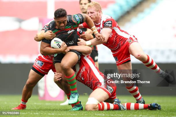 Tevita Tatola of the Rabbitohs is tackled by the Dragons defence during the round 10 NRL match between the South Sydney Rabbitohs and the St George...