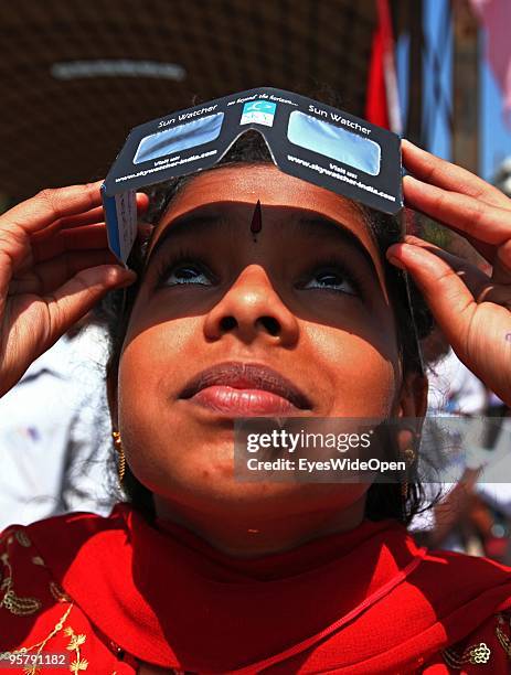 Indian young woman observes the rare Annular Solar Eclipse at the central stadium on January 15, 2010 in Thiruvananthapuram , Kerala, South...