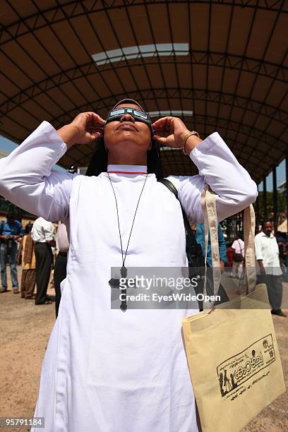 Indian christian nun observes the rare Annular Solar Eclipse at the central stadium on January 15, 2010 in Thiruvananthapuram , Kerala, South...