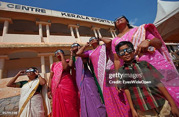 Indian people observe the rare Annular Solar Eclipse at the central stadium on January 15, 2010 in Thiruvananthapuram , Kerala, South India.This rare...