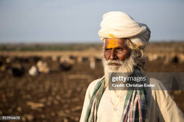 Portrait of an indian Shepherd with turban and in traditional clothes at work. As Hindu man he is signed with a yellow Tilaka.