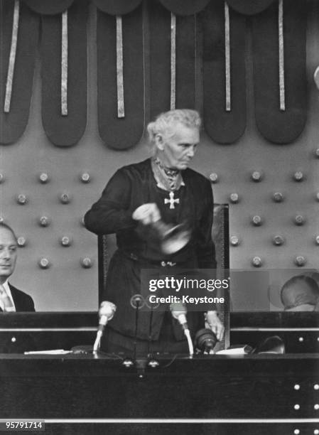 German politician and women's rights activist Marie Elisabeth Lueders rings the presidential bell to open the first session of the second Bundestag...