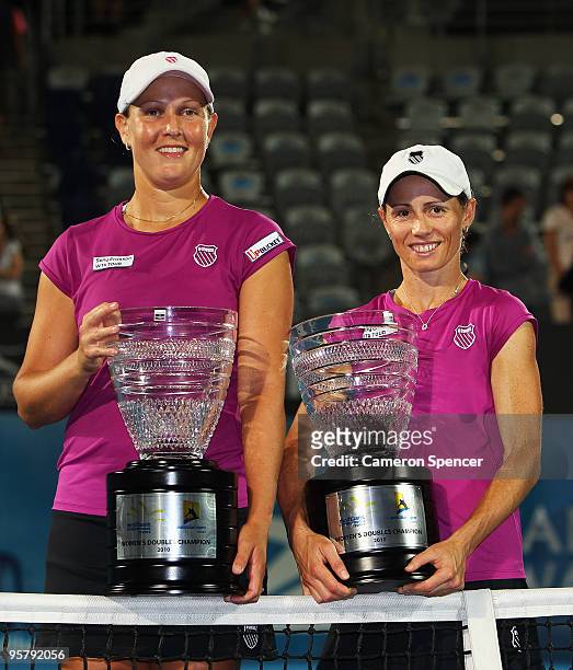 Liezel Huber of the USA and Cara Black of Zimbabwe pose with their trophies after winning the women's doubles final match against Tathiana Garbin of...
