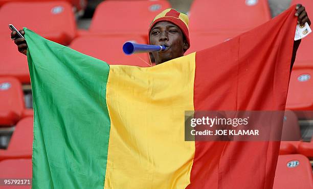 Mali fan waves a flag during 2nd round qualifing match of African Cup of Nations football championships CAN2010 between Algeria and Mali at November...