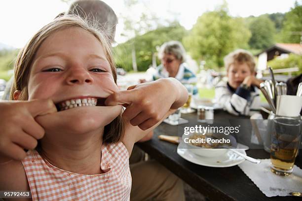 young girl making a grimace - funny face stockfoto's en -beelden