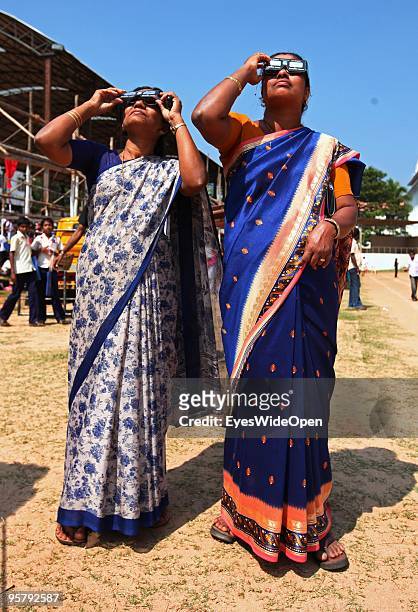 Indian people observe the rare Annular Solar Eclipse on January 15, 2010 at the central stadium of Thiruvananthapuram in Kerala, South India.This...