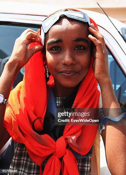 Indian girl observes the rare Annular Solar Eclipse on January 15, 2010 at the central stadium of Thiruvananthapuram in Kerala, South India.This rare...