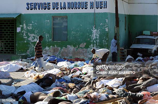 Worker of the morgue injects the bodies of victims to retard its putrefaction, outside the morgue in Port-au-Prince on January 14 following a...