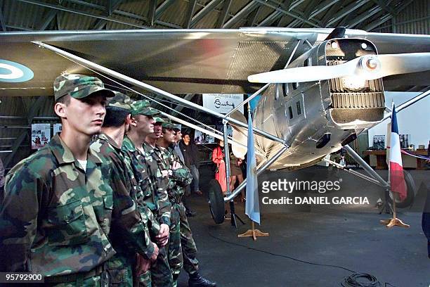 Argentine Air Force personnel stand before French writer and pilot Antoine de Saint-Exupery's Latecoere 25 airplane in Buenos Aires 17 April 2000....