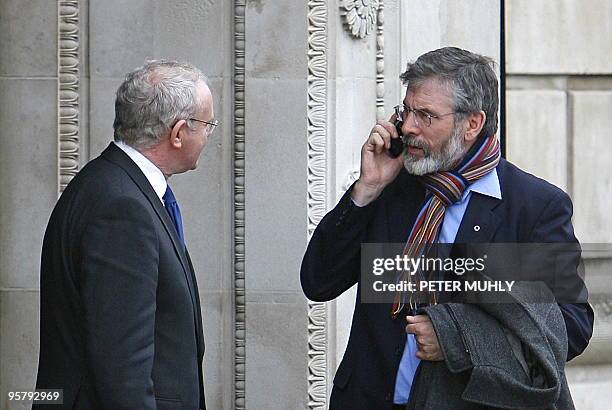 Sinn Fein president Gerry Adams speaks with Northern Ireland's Deputy First Minister Martin McGuinness outside Stormont Parliament building in...