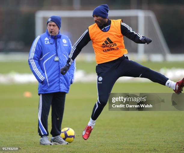 Nicolas Anelka of Chelsea shoots at goal and watched by Chelsea manager Carlo Ancelotti during a training session at the Cobham training ground on...