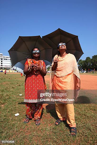 Indian people observe the rare Annular Solar Eclipse on January 15, 2010 at the central stadium of Thiruvananthapuram in Kerala, South India.This...