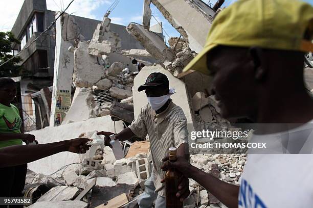 People search dead relatives inside a destroyed building in Port-au-Prince, on January 14 following the devastating earthquake that rocked Haiti on...