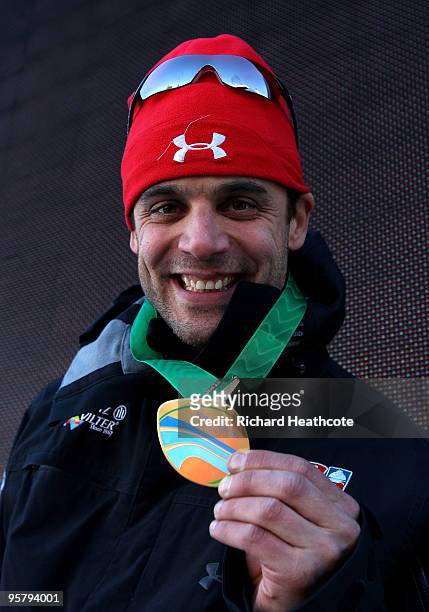 Eric Bernotas of the USA shows off his gold medal for winning the Men's FIBT Skeleton World Cup round 7 at the Olympic Bobrun on January 15, 2010 in...
