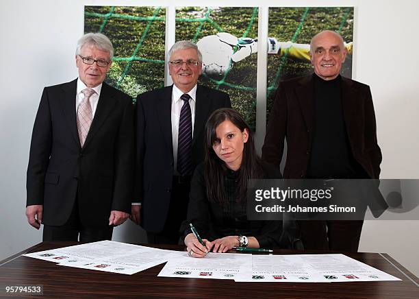 Teresa Enke , widow of goalkeeper Robert Enke signs the charter of the Robert Enke Foundation in presence of DFB officials Reinhard Rauball, Theo...